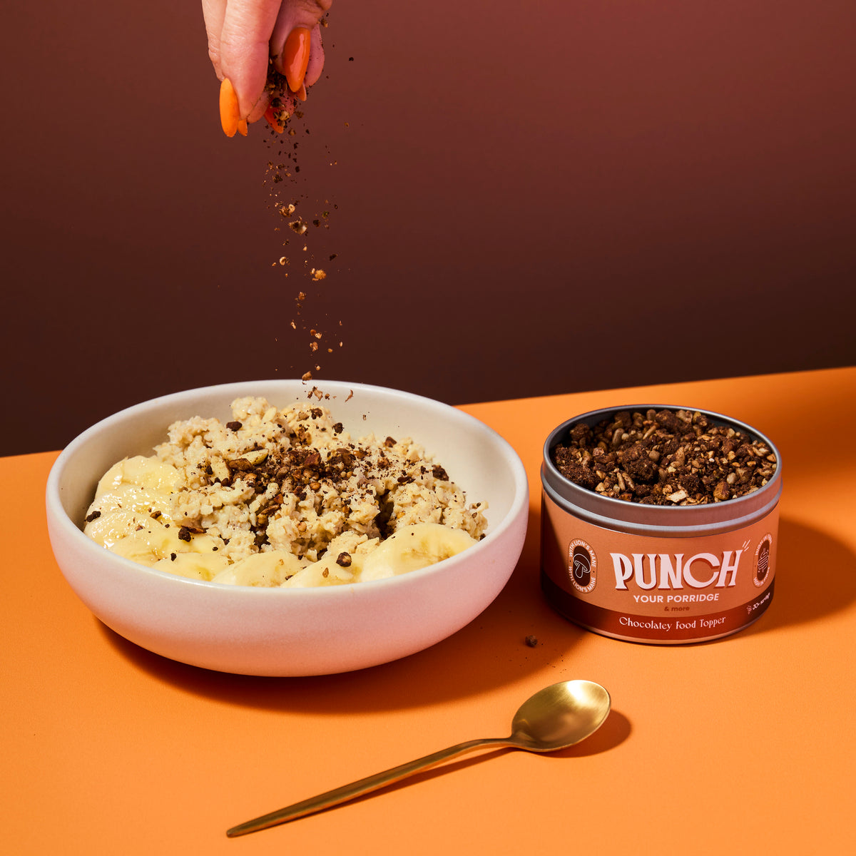 Bowl of oats with a tin of Punch your oats chocolatey food topper