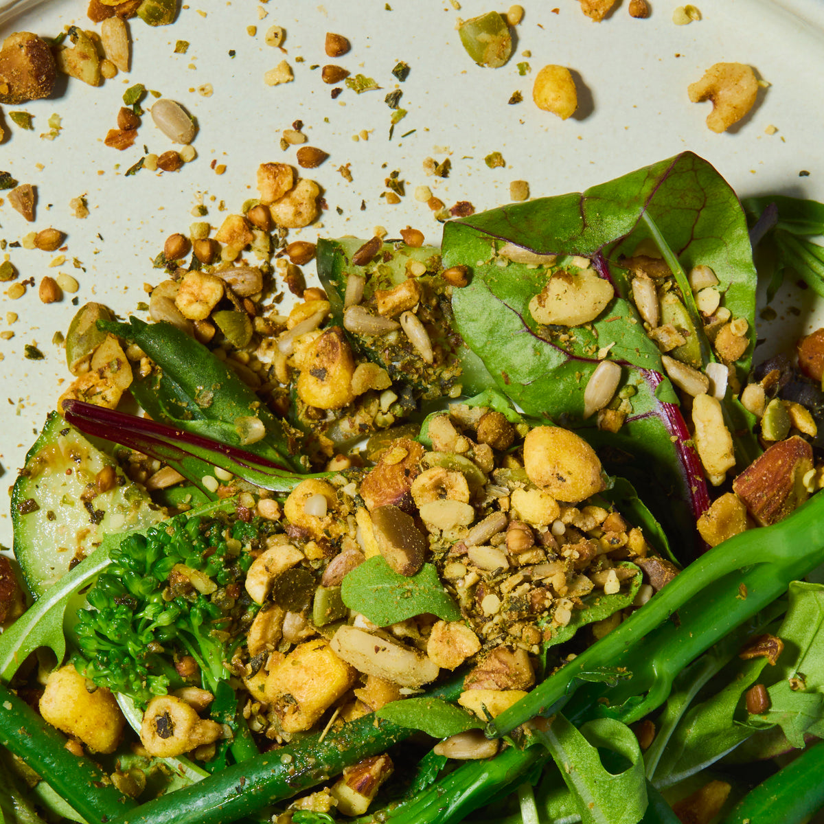 Close-up of a salad with green leaves and punch your salad food topper on a white plate.