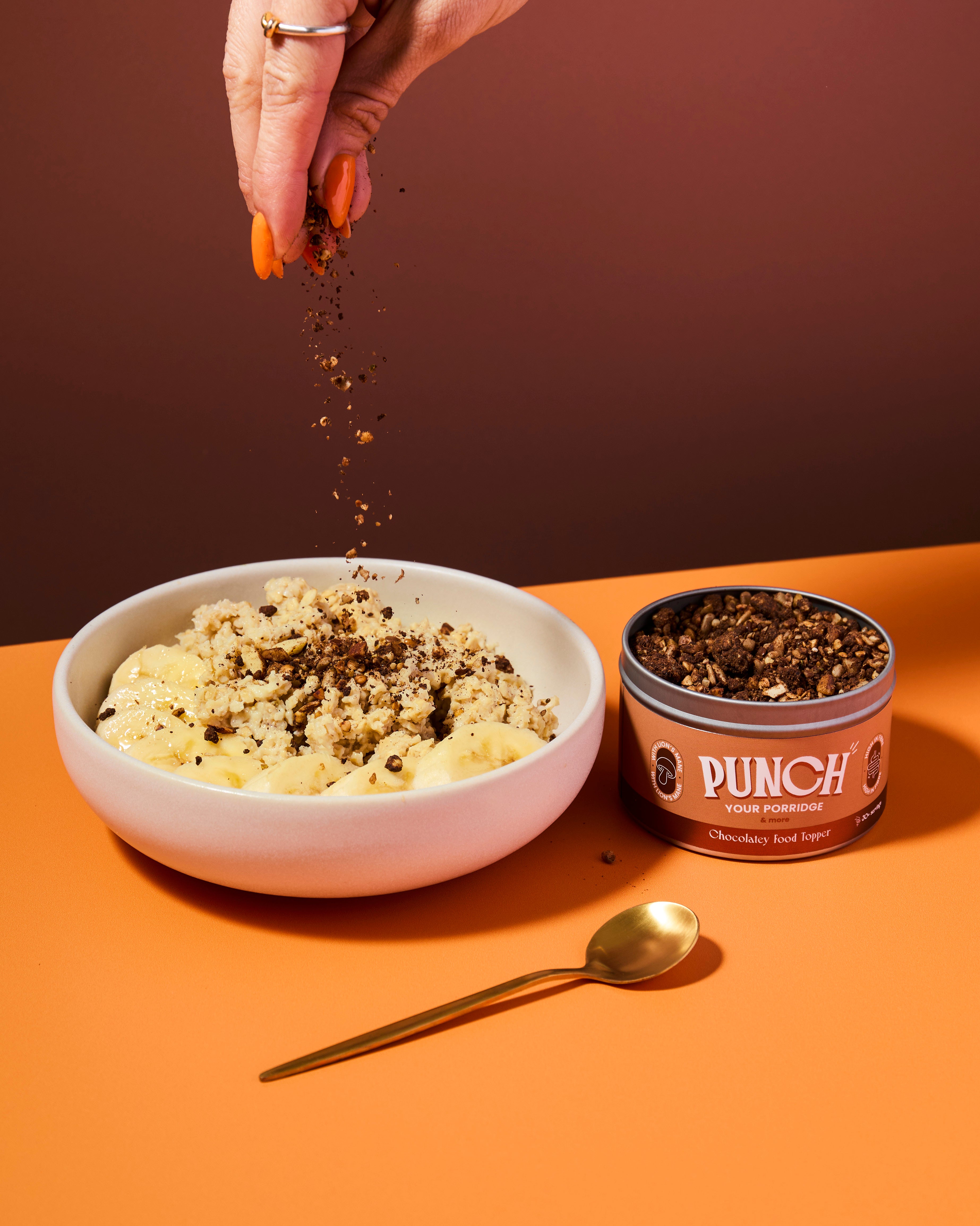 Bowl of oats with a tin of Punch your oats chocolatey food topper
