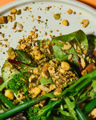 Close-up of a salad with green leaves and punch your salad food topper on a white plate.