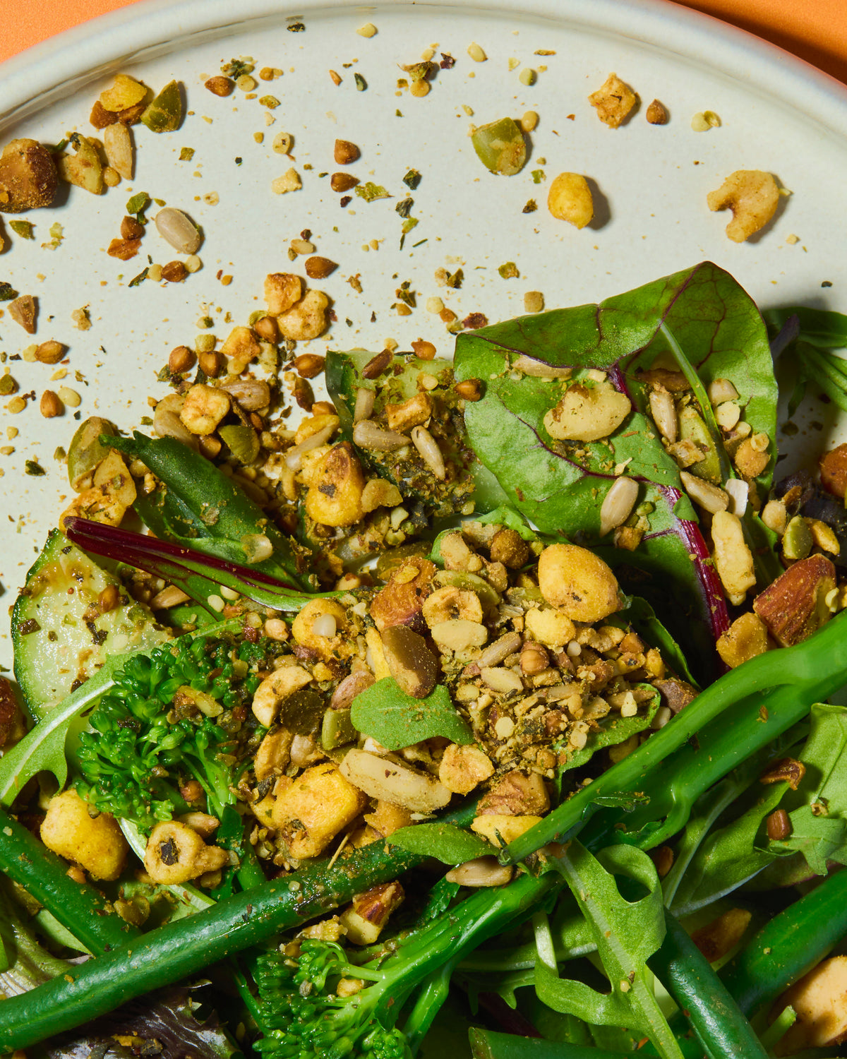 Close-up of a salad with green leaves and punch your salad food topper on a white plate.
