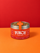 A tin of PUNCH Your Pasta Hearty Food Topper, featuring a bright red label and silver lid, set against a split orange and red background.