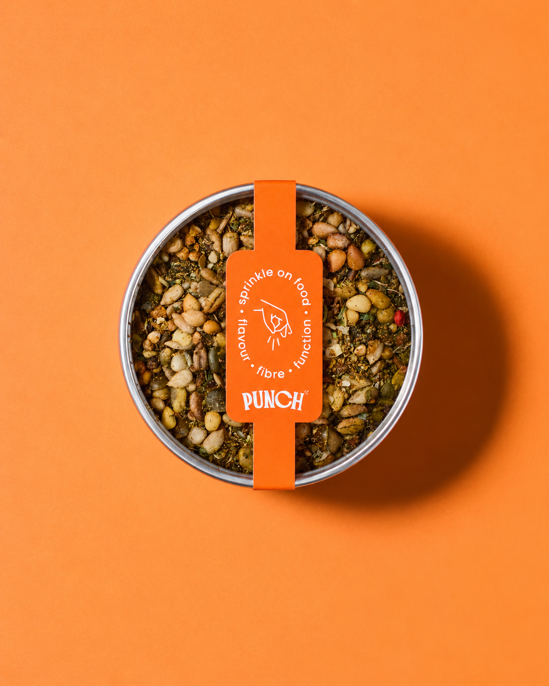 A top-down view of a round metal tin filled with a granular supplement blend, featuring a bright orange paper band label with the brand name 'PUNCH'. The product is set against a solid orange background.