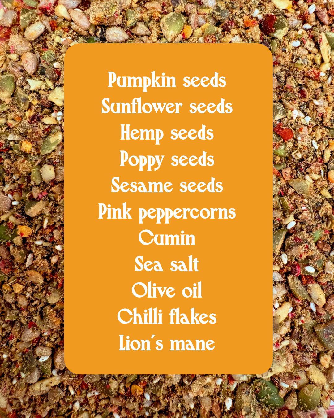 A flat-lay product shot of a spice blend featuring pumpkin seeds, sunflower seeds, hemp seeds, poppy seeds, sesame seeds, pink peppercorns, cumin, sea salt, olive oil, chili flakes, and lion's mane, presented on a textured background with a central orange label listing the ingredients.